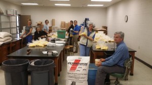 Volunteers gathered to prepare yard-size packages of fire ant sterilant, complete with application instructions.