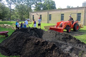 Neighborhood volunteers filled and leveled the beds with the help of a front-end loader.