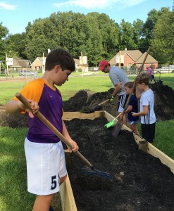 The Thompson family (left to right, Christian, dad Chad, Neala, and Jonathan) helped fill the raised beds.